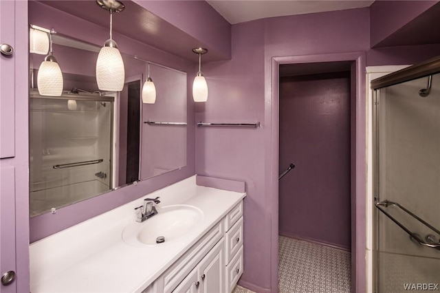 bathroom with vanity and a shower with shower door