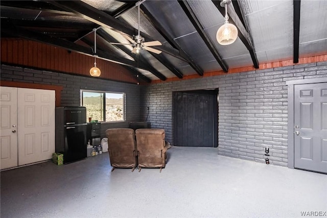 sitting room with vaulted ceiling with beams, brick wall, and ceiling fan