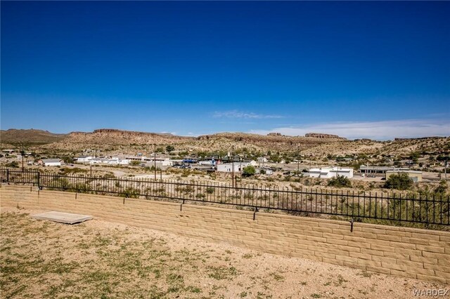 view of yard featuring fence and a mountain view