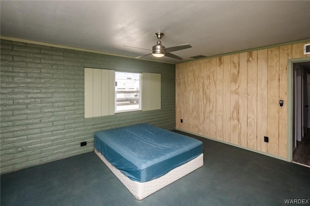 unfurnished bedroom with brick wall, visible vents, ceiling fan, and dark colored carpet