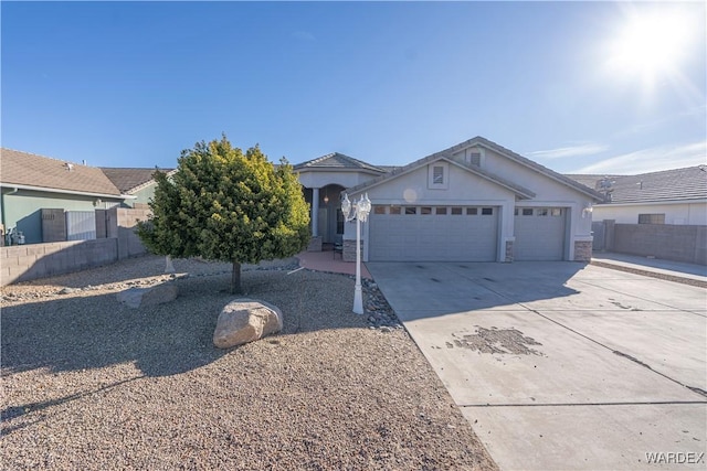 single story home with an attached garage, fence, concrete driveway, stone siding, and stucco siding