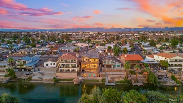 aerial view at dusk with a residential view and a water and mountain view