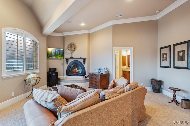 living area featuring light carpet, a warm lit fireplace, baseboards, and crown molding