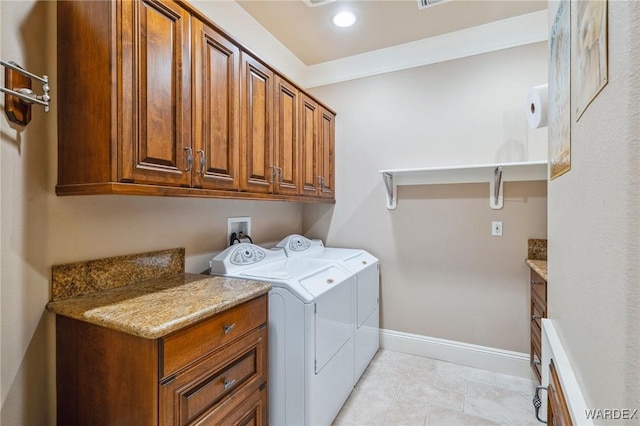 clothes washing area featuring light tile patterned floors, baseboards, cabinet space, washer and clothes dryer, and crown molding