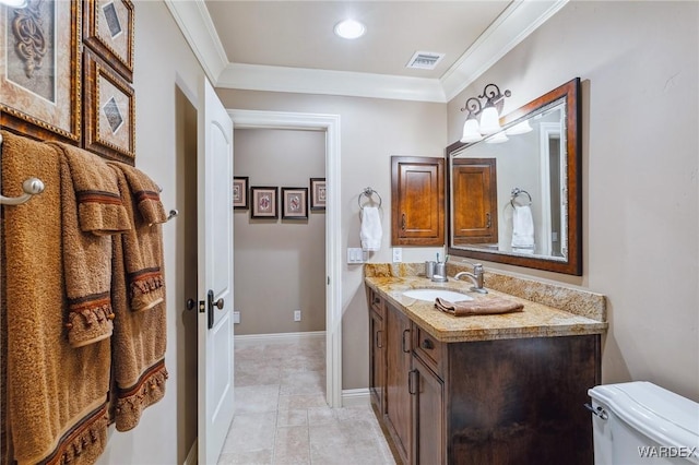 bathroom featuring toilet, visible vents, vanity, baseboards, and ornamental molding