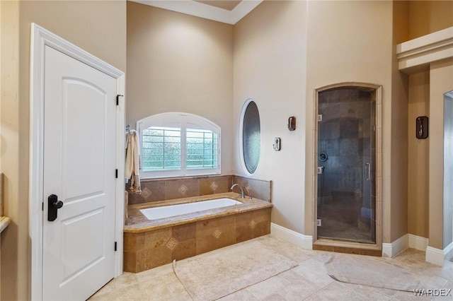 full bath with tile patterned flooring, a garden tub, and a shower stall