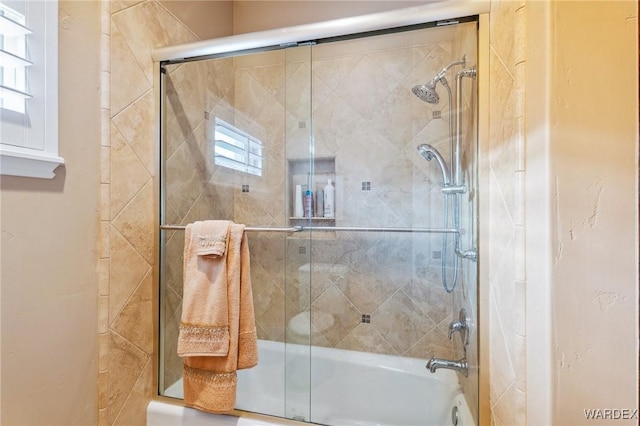 bathroom featuring bath / shower combo with glass door