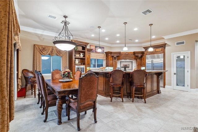 dining room featuring baseboards, visible vents, crown molding, and recessed lighting