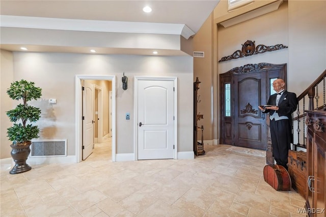 foyer with recessed lighting, visible vents, baseboards, and stairs