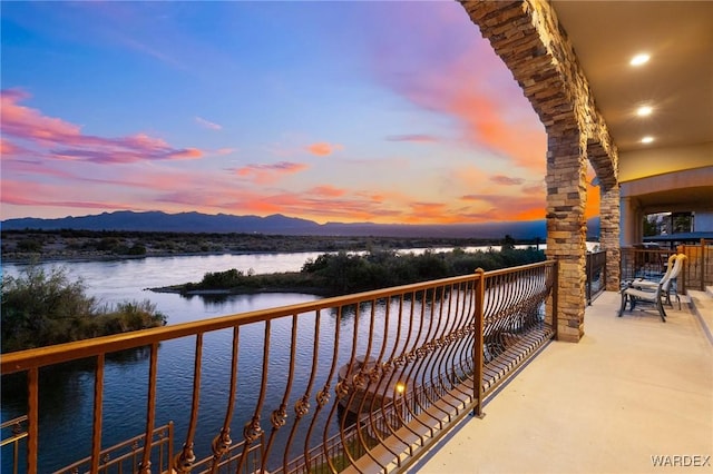 balcony with a water and mountain view