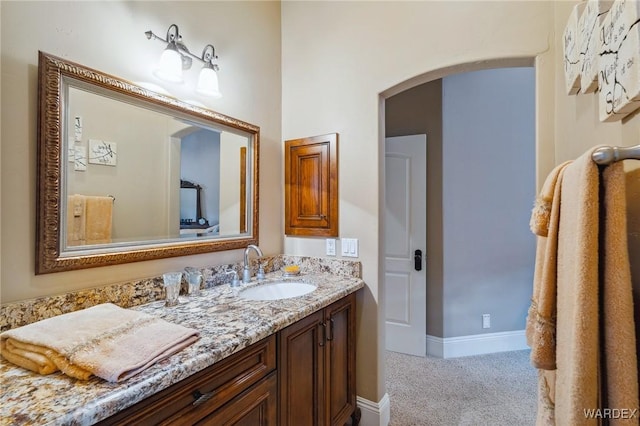 bathroom with vanity and baseboards