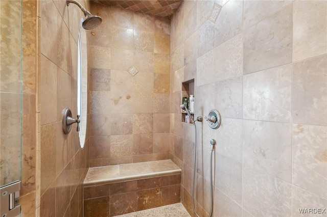 full bath with a tile shower