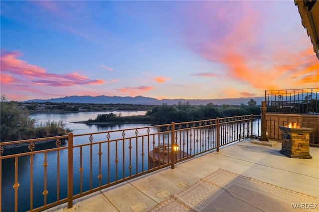 view of patio / terrace featuring a balcony and a water and mountain view