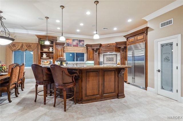 kitchen with built in fridge, visible vents, hanging light fixtures, ornamental molding, and open shelves