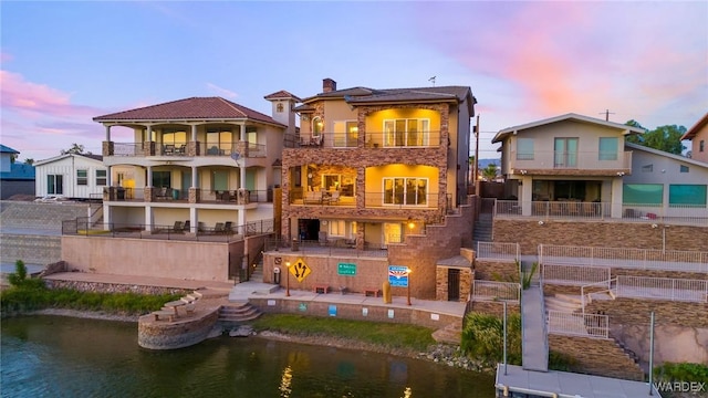 rear view of property with a water view and a chimney