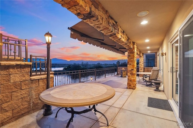 patio terrace at dusk with a water view