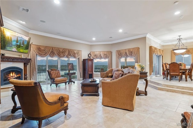 living room featuring a warm lit fireplace, recessed lighting, visible vents, and crown molding