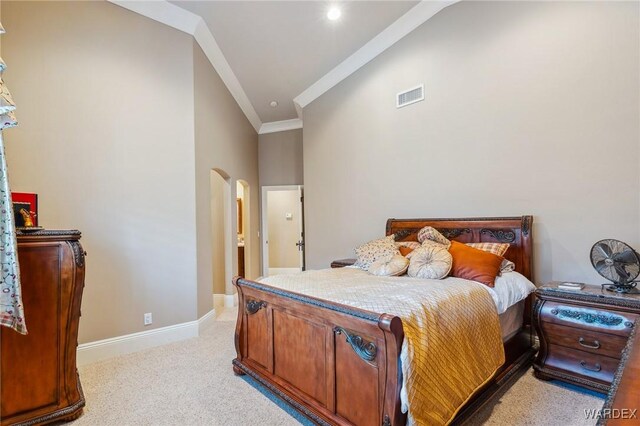 bedroom featuring arched walkways, crown molding, light colored carpet, visible vents, and baseboards