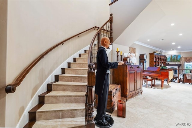 stairs featuring crown molding and recessed lighting