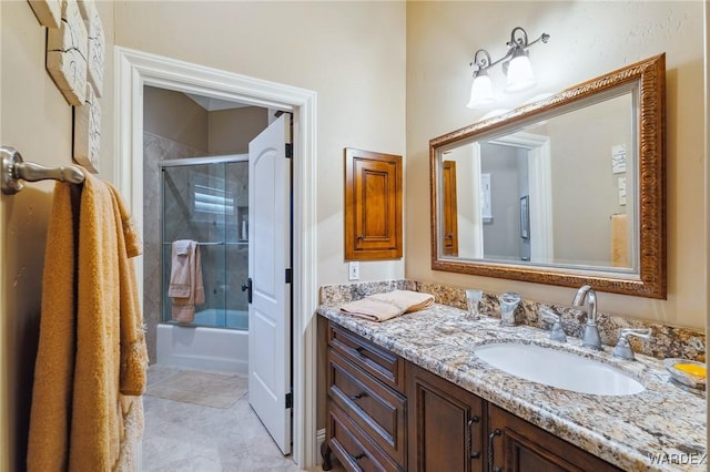 bathroom with shower / bath combination with glass door, tile patterned flooring, and vanity