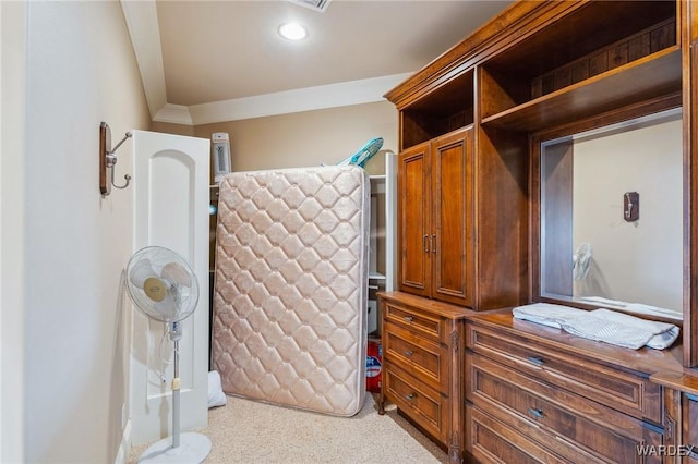 bedroom with light carpet and crown molding