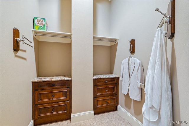 spacious closet featuring light carpet