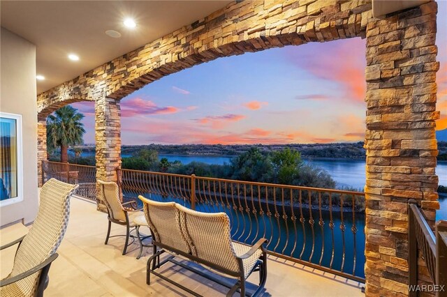 patio terrace at dusk with a water view