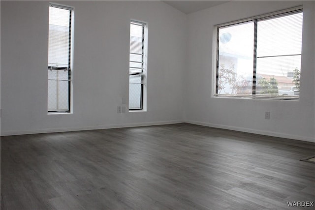 empty room with baseboards and wood finished floors