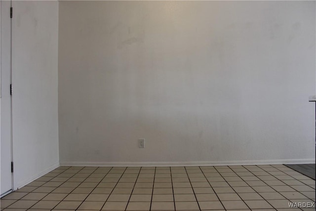 unfurnished room with baseboards