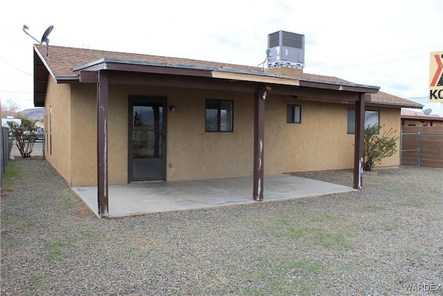 back of house with a patio, central AC unit, fence, and stucco siding