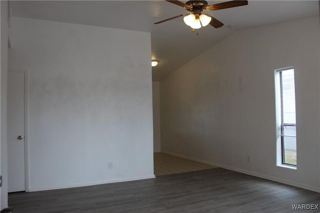 unfurnished room featuring a ceiling fan, vaulted ceiling, baseboards, and wood finished floors