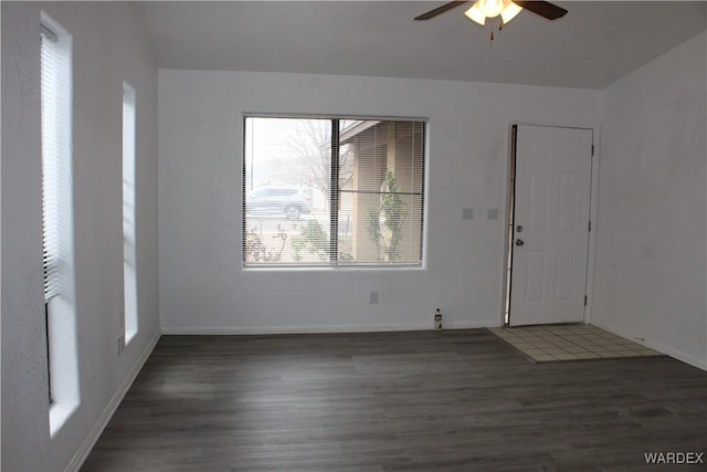 interior space with a ceiling fan, baseboards, and wood finished floors