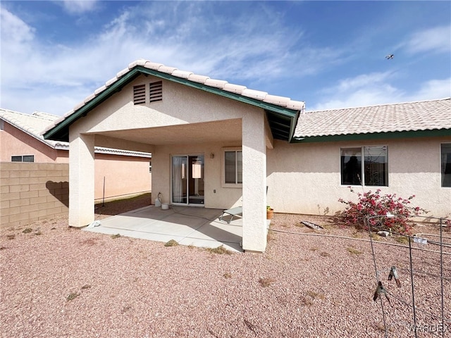 back of house with a patio, fence, a tiled roof, and stucco siding