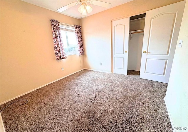 unfurnished bedroom with carpet, baseboards, ceiling fan, and a closet