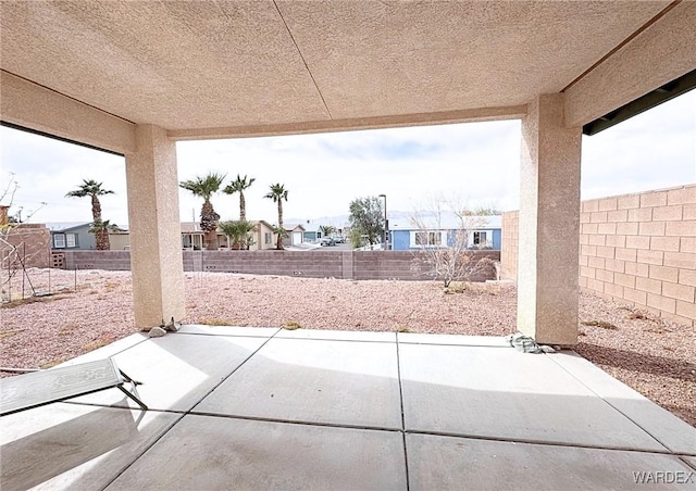 view of patio with a residential view and a fenced backyard