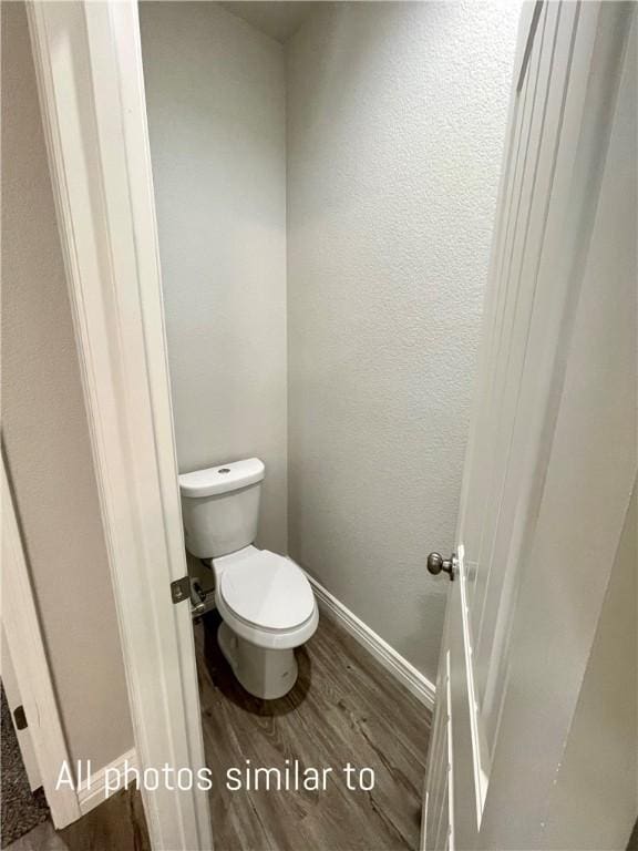 3371 N Apache St, Kingman, AZ 86401 - bathroom with wood finished floors, toilet, and baseboards