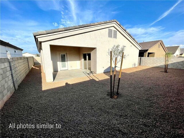 3371 N Apache St, Kingman, AZ 86401 - rear view of property with stucco siding, a fenced backyard, and a patio area