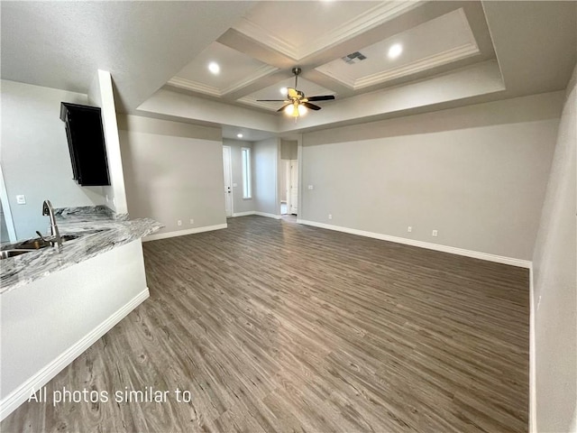 3371 N Apache St, Kingman, AZ 86401 - unfurnished living room with wood finished floors, ceiling fan, baseboards, coffered ceiling, and a sink