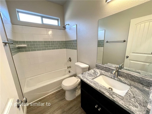 3371 N Apache St, Kingman, AZ 86401 - bathroom with toilet, wood finished floors, bathtub / shower combination, and vanity