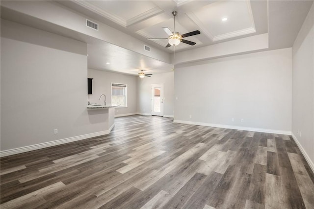 spare room featuring a ceiling fan, coffered ceiling, baseboards, dark wood-type flooring, and beamed ceiling