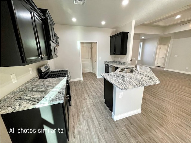 3371 N Apache St, Kingman, AZ 86401 - kitchen featuring a sink, dark cabinets, appliances with stainless steel finishes, a peninsula, and recessed lighting