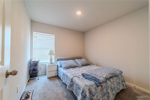 bedroom with light carpet and baseboards