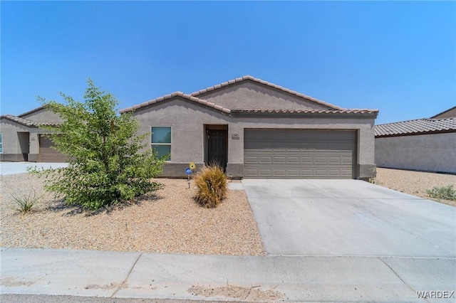 single story home with an attached garage, stucco siding, concrete driveway, and a tiled roof