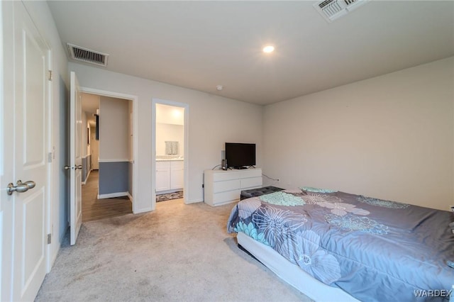 bedroom featuring visible vents and light colored carpet