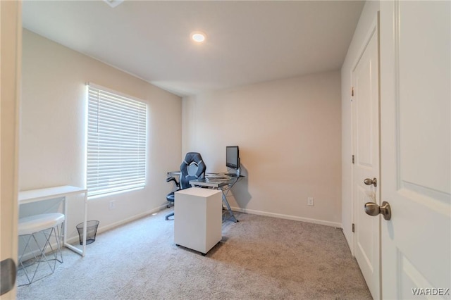 office space featuring light carpet and baseboards