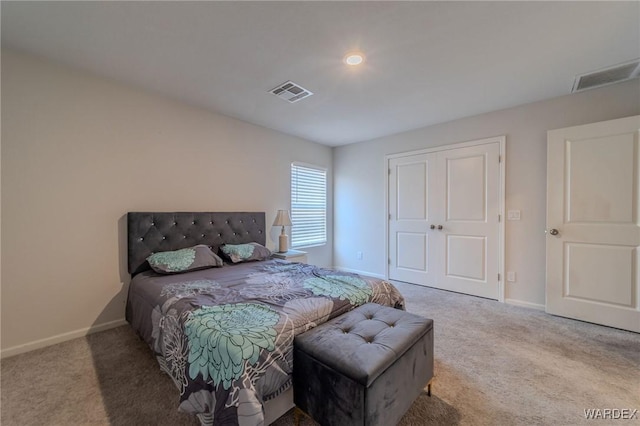 carpeted bedroom with a closet, visible vents, and baseboards