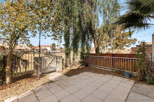 view of patio featuring a fenced backyard and a gate