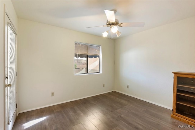 unfurnished bedroom featuring ceiling fan, dark wood-style flooring, and baseboards