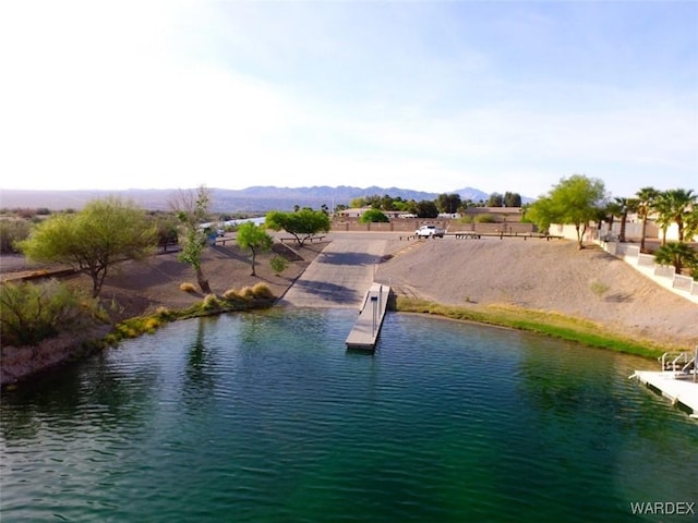 water view with a mountain view and a boat dock