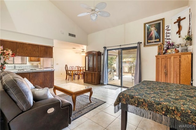 living room featuring high vaulted ceiling, light tile patterned flooring, ceiling fan, and visible vents